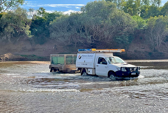 Wattnow Hilux crossing river on way to work in remote community 2022 Wattnow car driving across a river to service remote communities
